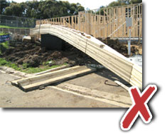 Photo showing trusses bending as they are lifted because slings are not attached to panel points.