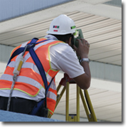 Photo of a surveyor taking measurements.