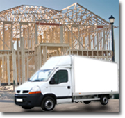 Photo of a delivery van in front of a timber framed house.