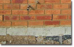 Picture of a wall with weep holes. 