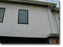 Photo of a building with a wall covered in cladding.