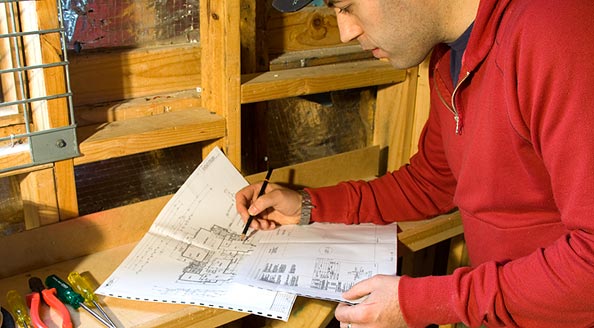 Photo showing a worker studying a diagram