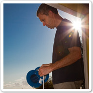 Photo showing a worker outside, dressed in shorts and t-shirt