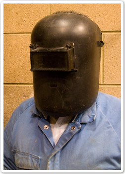 Photo of worker wearing a welding helmet