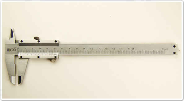 Photo of a precision measuring tool that has a sliding jaw and scale